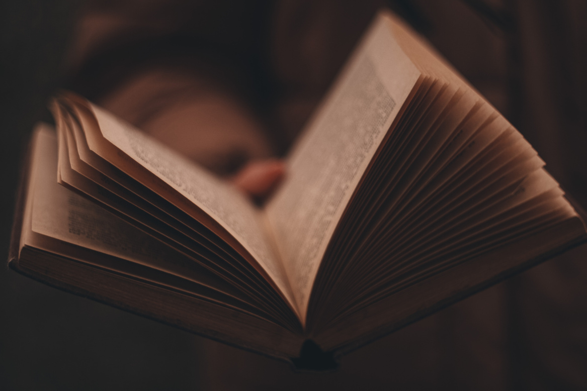 Person Lying on White Book